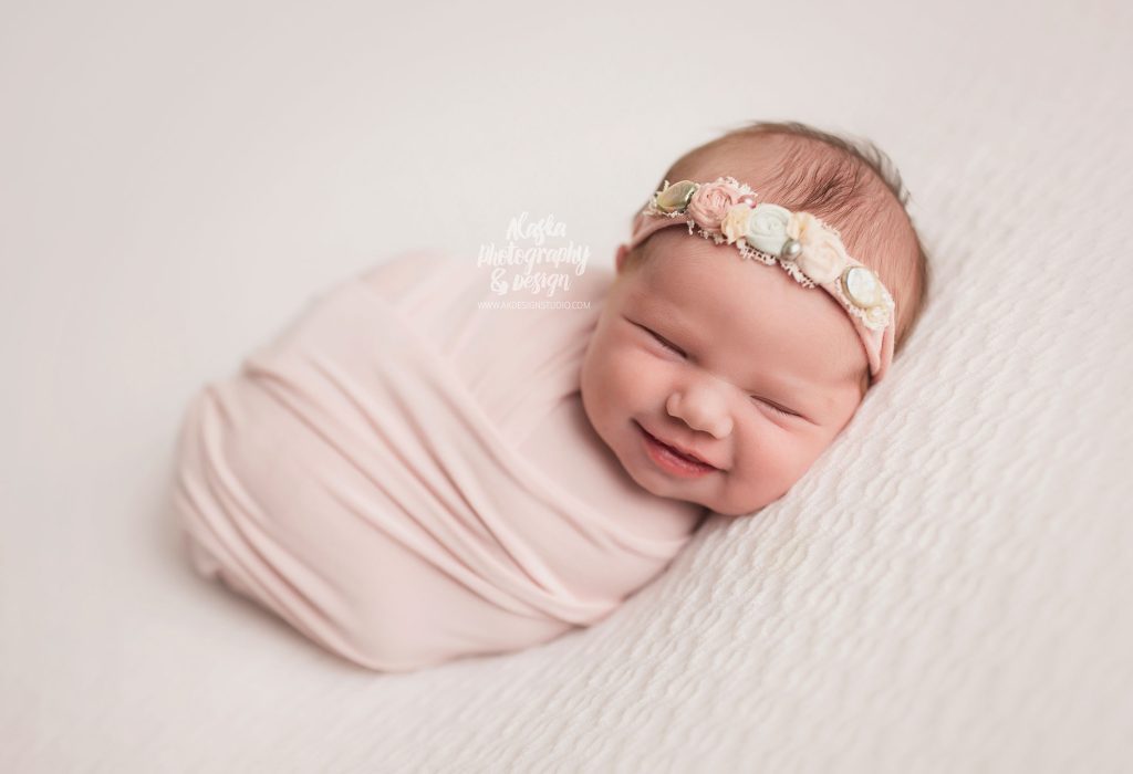 newborn baby girl smiling